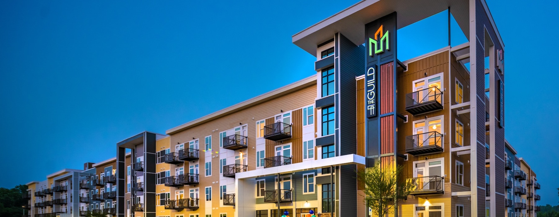 evening exterior building view of The Guild Apartments in Pittsboro, NC